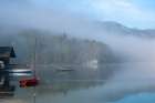 Slovenia, Lake Bohinj. Lake boats on foggy morning. Art Print